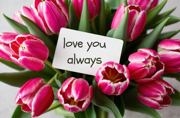 i love you always inscription text on a note on a background of flowers