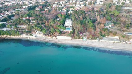 Wall Mural - Drone view of a villa with pool in the lush forest next to the beach, the sea is wonderful turquoise