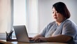 © ochikosan - ノートパソコンを使って在宅勤務をしいているふくよかなアジア人女性（Fat Asian woman working from home using a laptop）