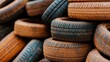 © gilemixmedia - A creative arrangement of mixed tires displayed in a stack, emphasizing their industrial quality along with a natural backdrop that enhances the textures and colors.