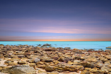 Wall Mural - beautiful seascape on sunset sky. panoramic landscape of rocky coast and sea. sea surface in sun lig