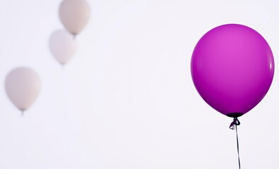 Wall Mural - Vibrant purple balloon, white balloons, minimalist composition, clean background, contrasting colors, floating balloons, celebratory atmosphere, simple elegance, party decoration, pop of color, negati