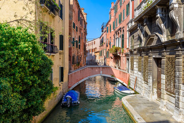 Wall Mural - narrow canal with boat and bridge in venice, italy. architecture and landmark of venice. cozy citysc