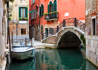 Wall Mural - narrow canal with bridge in venice, italy. architecture and landmark of venice. cozy cityscape of ve