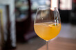 © moomusician - A glass of citrus sangria, featuring a vibrant orange hue with ice and a slice of fruit garnish
