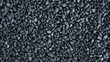 © ThomasStockArt - Black gravel background with small pebbles, close-up view