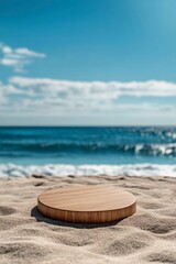 Wall Mural - A round wooden podium on the beach with a blue sea and sky background, a close-up shot of a wood product display stand in the sand for summer advertising. 