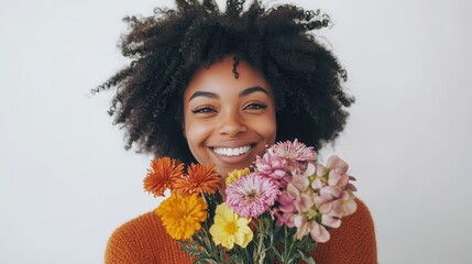 Wall Mural - A young woman holding a bunch of flowers, smiling joyfully, on a white isolated background