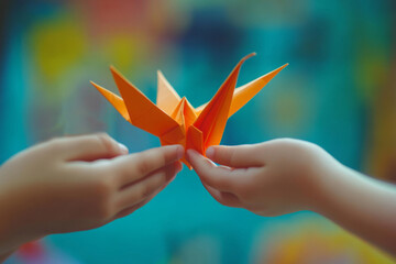 Two children holding an orange origami crane, representing peace, hope, and the beauty of paper art