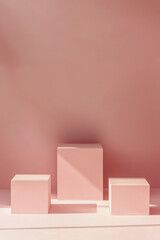 Sticker - A minimalistic and clean background with three simple, square pedestals in shades of blush pink, arranged neatly to create an elegant display for product photography.