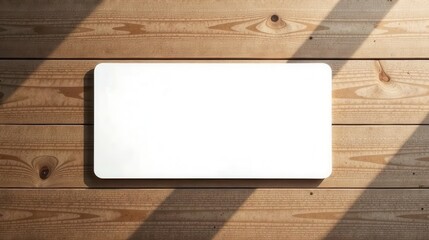 Aufkleber - Blank rectangle on a light brown wood surface with sunlight shadows