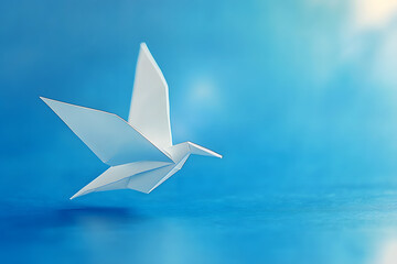 Sticker - White Paper Origami Bird Against a Blue Background, Celebrating World Peace Day, Day Against Humiliation, and International Day of Human Fraternity.