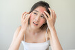 © KMPZZZ - Dermatology, scratch asian young woman, girl expression face worry, hand itch, itchy allergy or allergic sensitive reaction, red spot or rash on her facial. Beauty care from skin problem treatment.