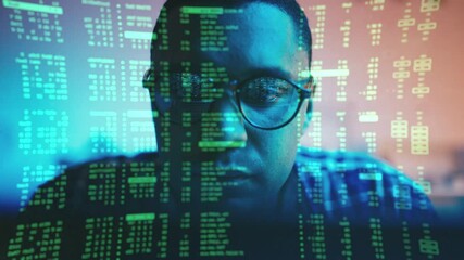 Male hacker writes hacking code while sitting behind holographic computer screen