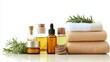 © Oppilamani - Arrangement of Natural Oils, Face Creams, and Serums with Fresh Towels on a White Background, Providing Space for a Personalized Message