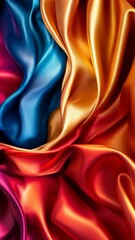 Wall Mural - vibrant silk fabric displaying a blend of blue, gold, red, and orange hues in an artistic arrangemen