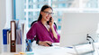 © Home-stock - Happy young businesswoman executive manager talking on cellphone, making business call at work in office using modern computer at workplace