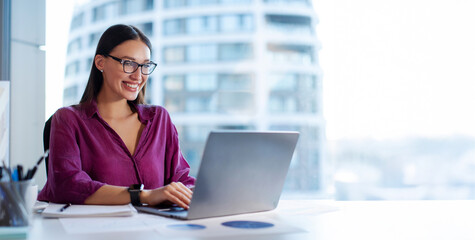 successful young woman working on laptop in office, tech support worker typing on keyboard smiling, 