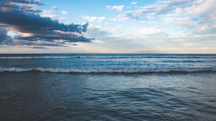 Wall Mural - Beach scenes whakatane new zealand fine sand dramatic sky sunset calm warm ocean

