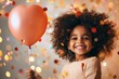 © Thanyarat - A child holding a balloon and smiling widely during a festive celebration, surrounded by colorful decorations
