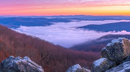 Wall Mural - Sunrise over a misty valley and rolling hills.