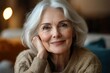 © tiger - Serene close-up portrait of thoughtful elderly woman smiling indoors, showcasing beauty and confidence in a cozy living room