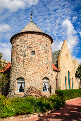 Wall Mural - A stone building with a steeple and a clock on the tower