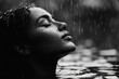 © Thanyarat - A person standing in the rain with their face tilted upwards, their expression serene as they soak in the moment with gratitude