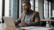 © Altaf - Zoom in of bearded caucasian businessman writing report on laptop at desk while working in open space office