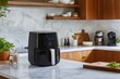 © MUHAMADFADZLAN - Modern Kitchen with Smart Air Fryer on Marble Counter