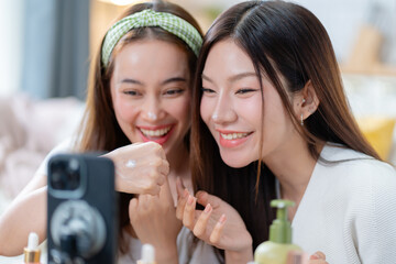 Young attractive two asian woman beauty blogger or vlogger,influencer share story selfie blog skincare vlog.Asia Gen Z influencer vlog apply face skin care make on video shooting and live streaming