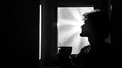 © Keattipoom - Contemplative Silhouette of a Man Holding a Cup by a Window with Sunlight Streaming Through in Black and White