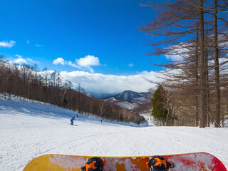 Wall Mural - Ski slope viewed from a resting snowboarder on a sunny day (Kawaba, Gunma, Japan)