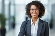 © nsit0108 - Portrait of a confident businesswoman smiling in a modern office environment