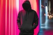 © Namdang - Mysterious Figure in Black Hoodie Against Colorful Neon Background