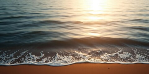 Wall Mural - a calming ocean scene with soft golden light and navy blue hues features gentle waves on a sandy sho