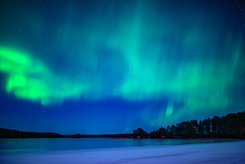 Wall Mural - northern lights dancing over frozen lake. farnebofjarden national park in north of sweden.