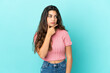 © luismolinero - Young caucasian woman isolated on blue background having doubts