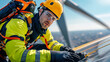 © kongkiat chairat - maintenance engineer working on wind turbine, wearing safety gear and focused on his task