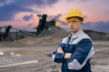 Wall Mural - Portrait worker Caucasian man industry engineer in hard hat at sand quarry during sunset survey