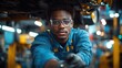 © Aris - A focused young African-American mechanic works under a car, his serious expression reflecting his concentration on the task.