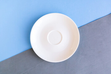 Empty plate on grey and blue background. Copy space for the text. Minimal concept