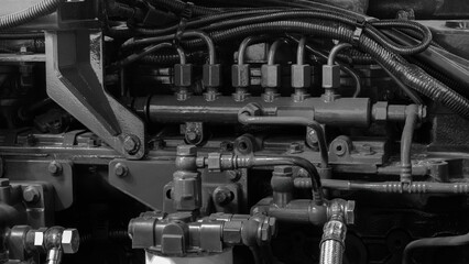 Aufkleber - A close up of a large engine with many pipes and valves. The engine is black and white