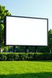 © supansa - Blank billboard in a park setting, ready for your advertisement message, surrounded by lush green grass and neatly trimmed hedges, idyllic outdoor location for impactful signage