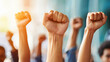 © Vilaysack - Raised fists in solidarity during protest, symbolizing unity and strength in diverse group of people. image captures powerful moment of activism and determination