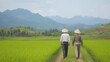 © Chanagun - Two farmers walking along a lush green path in a rice field, surrounded by rolling hills and mountains under a clear sky, symbolizing peace and harmony with nature.