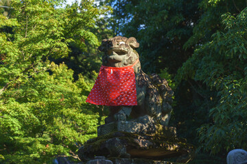 Kyoto, Japan - Sep 23 2024, A close-up view of the statue of a Japanese fox, kitsune, holding a golden object in its mouth, at the Fushimi Inari Temple Kyoto, Japan