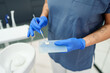 © Dorde - Dental Professional Mixing Cement with Precision and Care