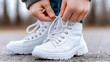 © Adamandgirls - Improved Understanding, A child learns to tie their shoes with parental guidance in this high-fidelity image, showcasing a heartfelt moment of learning and connection.