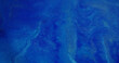 © golubovy - Wet ink texture. Blur paint flow. Blue white color blinking liquid shimmering dust moving on abstract art bokeh light background.